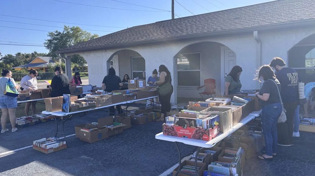 Tables of boxed books outside our New Port Richey warehouse at the monthly $1 book sale, where donated books that do not sell online are passed on locally.